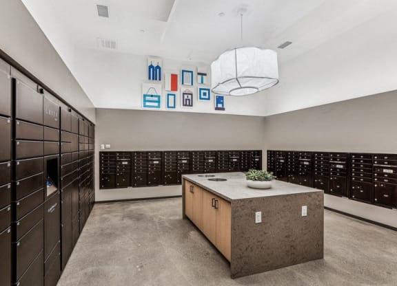 a large locker room with wooden cabinets and a table with a plant at Link Apartments® Four 12, California, 94607