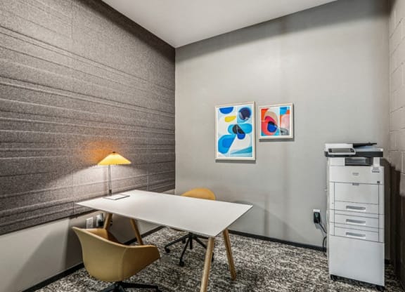 a conference room with a table and chairs and a filing cabinet at Link Apartments® Four 12, Oakland, 94607