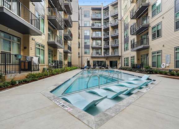 A swimming pool in front of apartment buildings. at Link Apartments® NoDa 36th Apartments, North Carolina