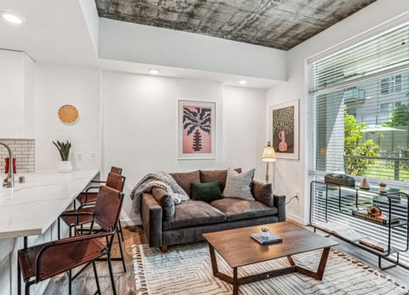 the living room of an apartment with a couch and a table at Link Apartments® Four 12, Oakland, CA, 94607