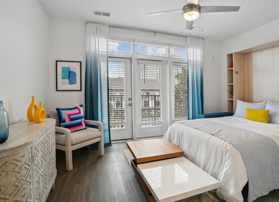 a bedroom with a bed and a sliding glass door at Link Apartments® Mint Street, Charlotte, North Carolina