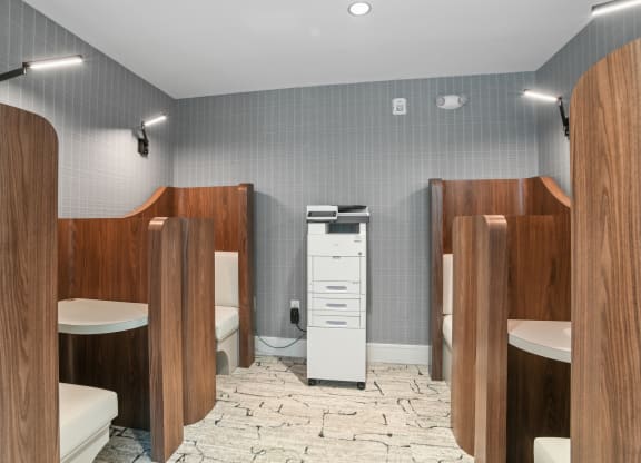 a bathroom with four stalls and a toilet and a sink at Link Apartments® Mint Street, Charlotte, North Carolina