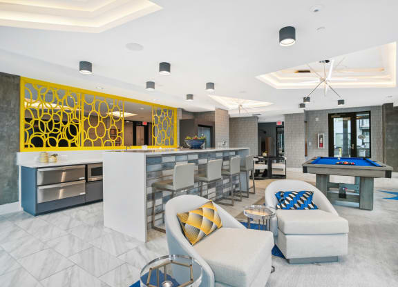 a clubhouse with a pool table and a bar at Link Apartments® Mint Street, North Carolina