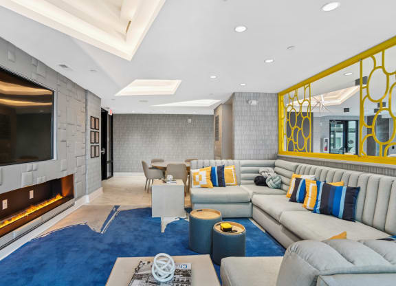 a living room with couches and a television and a fireplace at Link Apartments® Mint Street, Charlotte, NC