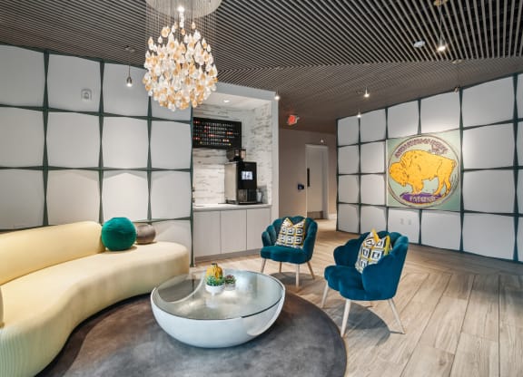 a living room with a couch and chairs and a coffee table at Link Apartments® Mint Street, Charlotte, NC, 28203