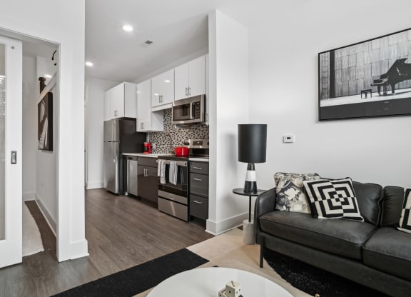 a living room with a couch and a table at Link Apartments® Mint Street, North Carolina