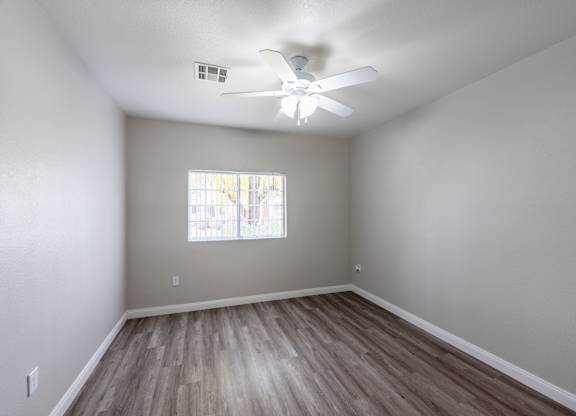 A room with a ceiling fan and a window. at Cheyenne Villas, North Las Vegas