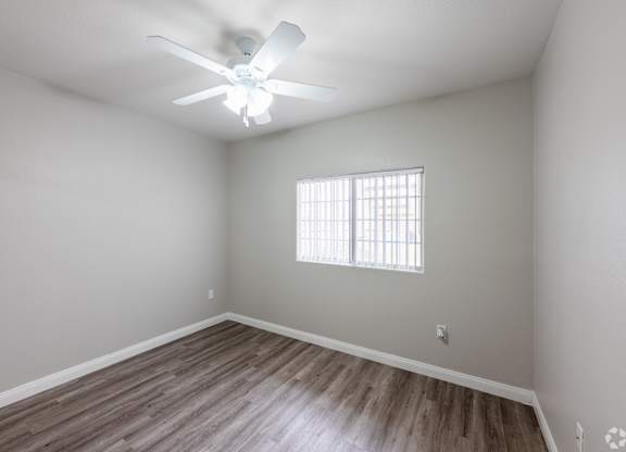 A room with a ceiling fan and wooden flooring. at Cheyenne Villas, North Las Vegas, NV, 89032