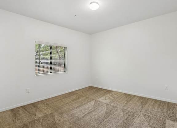 A room with a window and a carpet. at Rome Park Villas, Nevada, 89084