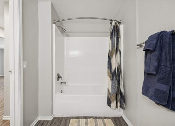 A bathroom with a towel hanging on the wall.