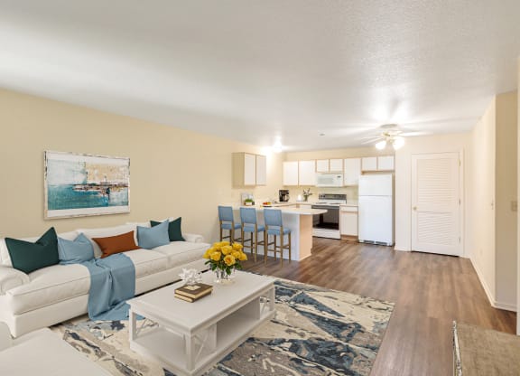 an open living room and kitchen with a white couch and table
