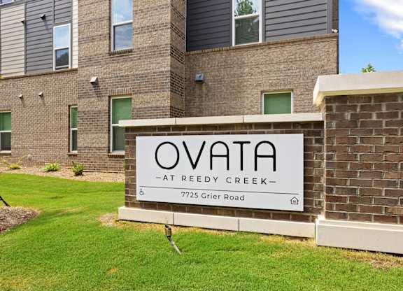 A sign that reads Ovata at Reedy Creek in front of Ovata at Reedy Creek Senior Apartments in Charlotte NC.