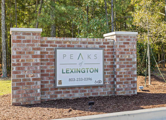 Peaks of Lexington Apartments Sign with Logo and Phone Number