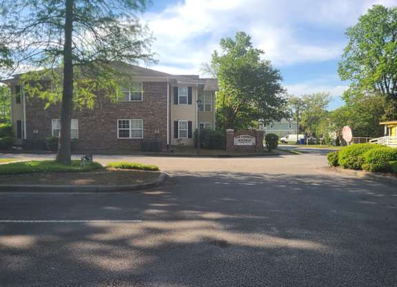 a large brick apartment building with a street in front of it