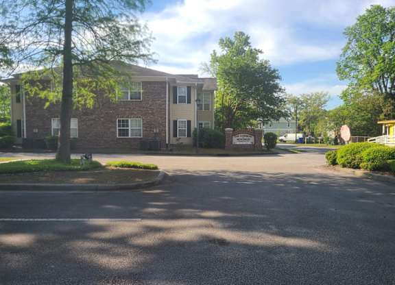 a large brick apartment building with a street in front of it