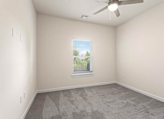 Peaks of Lexington Apartments Bedroom with Ceiling Fan, Light, Window and Gray Carpet