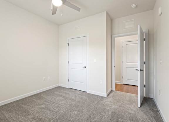 Peaks of Lexington Apartments Bedroom with Ceiling Fan, Light, Window and Gray Carpet