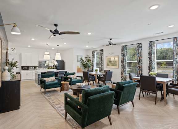 Ovata at Reedy Creek Senior Apartments in Charlotte NC community kitchen with modern appliances and dining room tables
