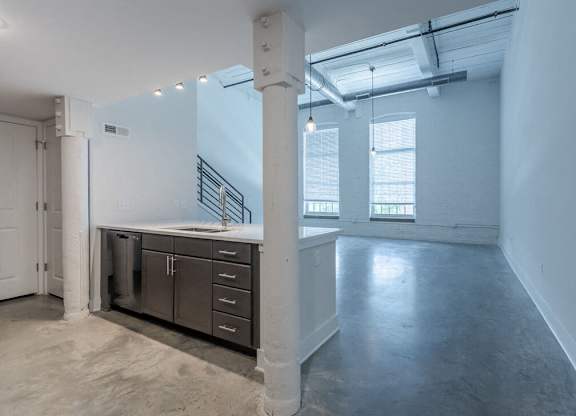 an empty room with a sink and a window