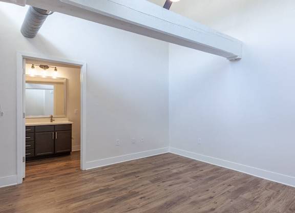 a living room with white walls and a wooden floor