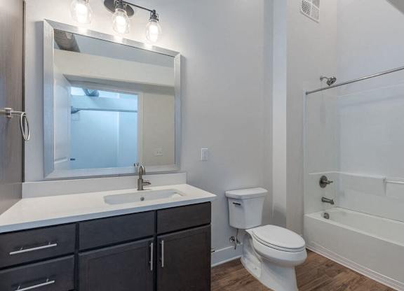 a bathroom with a sink toilet and a mirror
