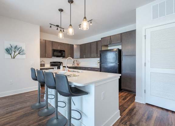 a kitchen with an island and bar stools