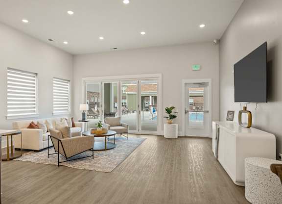 A modern living room with a wooden floor and white walls.