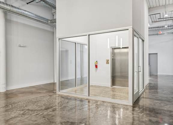 Elevator in glass room at Converse Mill Lofts in Spartanburg, SC