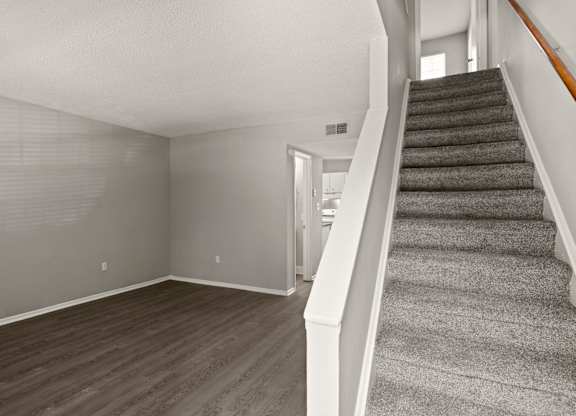 A room with a staircase leading to the upper floor.