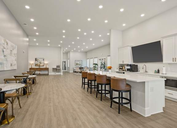 A modern kitchen with a bar area and a dining table.