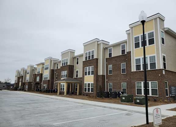 Apartment complex with a no parking sign in front.
