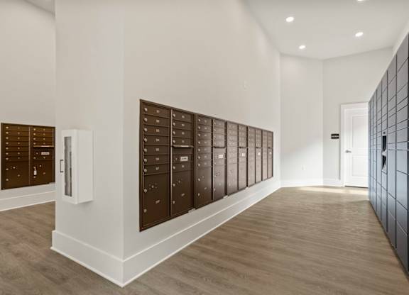 A hallway with a row of mailboxes on the wall.