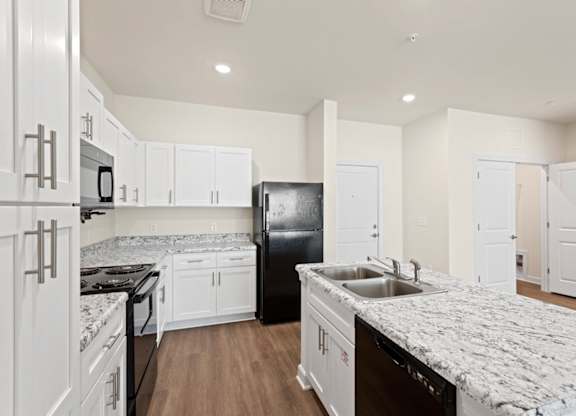 Peaks of Lexington Apartments Kitchen with Black Appliances, Granite Countertops and White Cabinetry