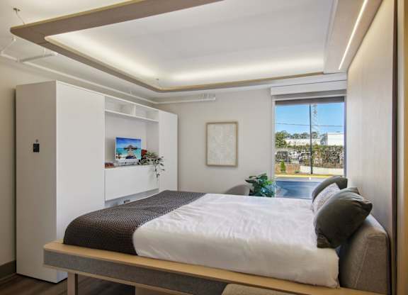 Greenville, SC Studios For Rent | Flathouse Studios | Bedroom with Ori Expandable Bed, Pocket Closet, and Large Window.