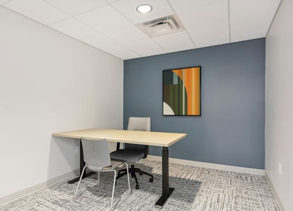 a meeting room with a table and chairs