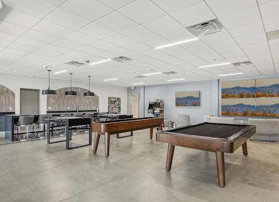1 Bedroom Apartments in Greenville, SC | Flathouse Studios | Gaming Lounge with Foosball, Shuffleboard, Billiards, and Full Swing Golf Simulator.