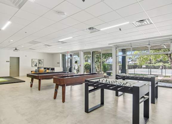 1 Bedroom Apartments in Greenville, SC | Flathouse Studios | Gaming Lounge with Foosball, Shuffleboard, Billiards, and Full Swing Golf Simulator.