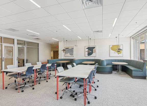 a large room with tables and chairs and couches