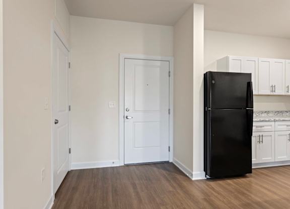 Peaks of Lexington Apartments Kitchen with Black Appliances, Granite Countertops and White Cabinetry
