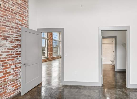 View from bathroom in Converse Mill Lofts in Spartanburg, SC, with connected bathroom and view of the living room
