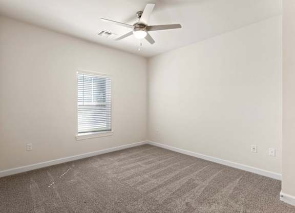 Peaks of Lexington Apartments Bedroom with Ceiling Fan, Light, Window and Gray Carpet