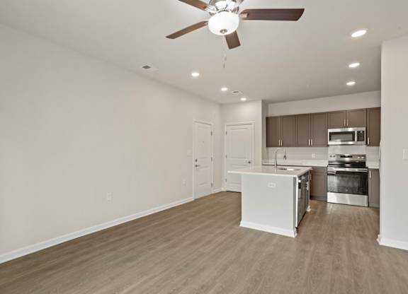 Grande at Geyser Falls Luxury Apartments Living Room and Kitchen with LVT Flooring