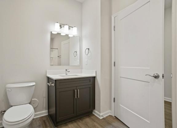 A white toilet sits next to a sink in a bathroom.