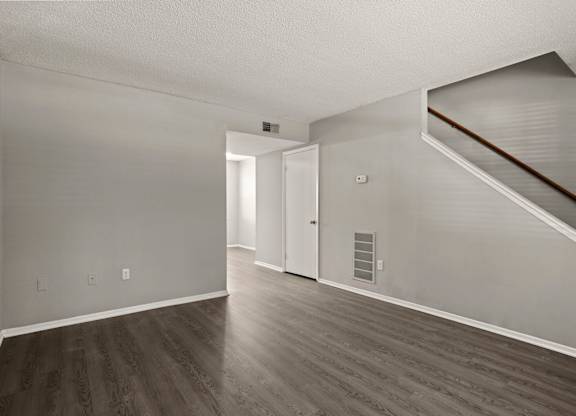 A room with a staircase and a door.