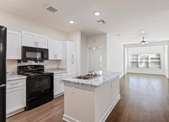 Peaks of Lexington Apartments Kitchen with Black Appliances, Granite Countertops and White Cabinetry