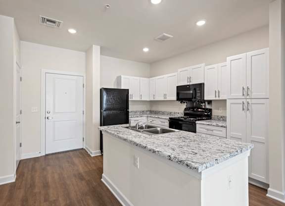 Peaks of Lexington Apartments Kitchen with Black Appliances, Granite Countertops and White Cabinetry