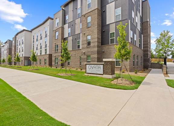 A sign that reads Ovata at Reedy Creek in front of Ovata at Reedy Creek Senior Apartments in Charlotte NC.