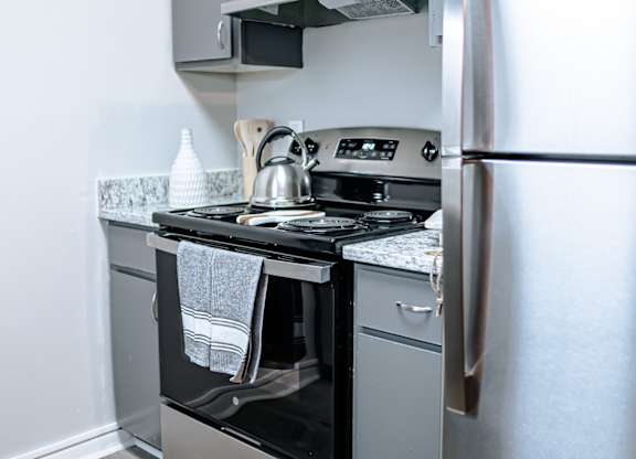 A kitchen with a stainless steel refrigerator, oven, and dishwasher.