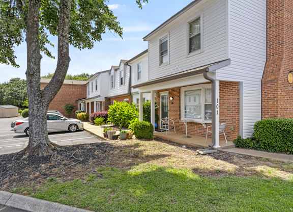 A tree is in front of a house.