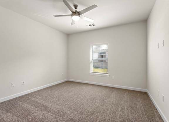 Peaks of Lexington Apartments Bedroom with Ceiling Fan, Light, Window and Gray Carpet